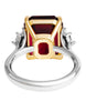 Three-stone ring with garnet center stone and diamond side stones in 18K yellow gold and platinum