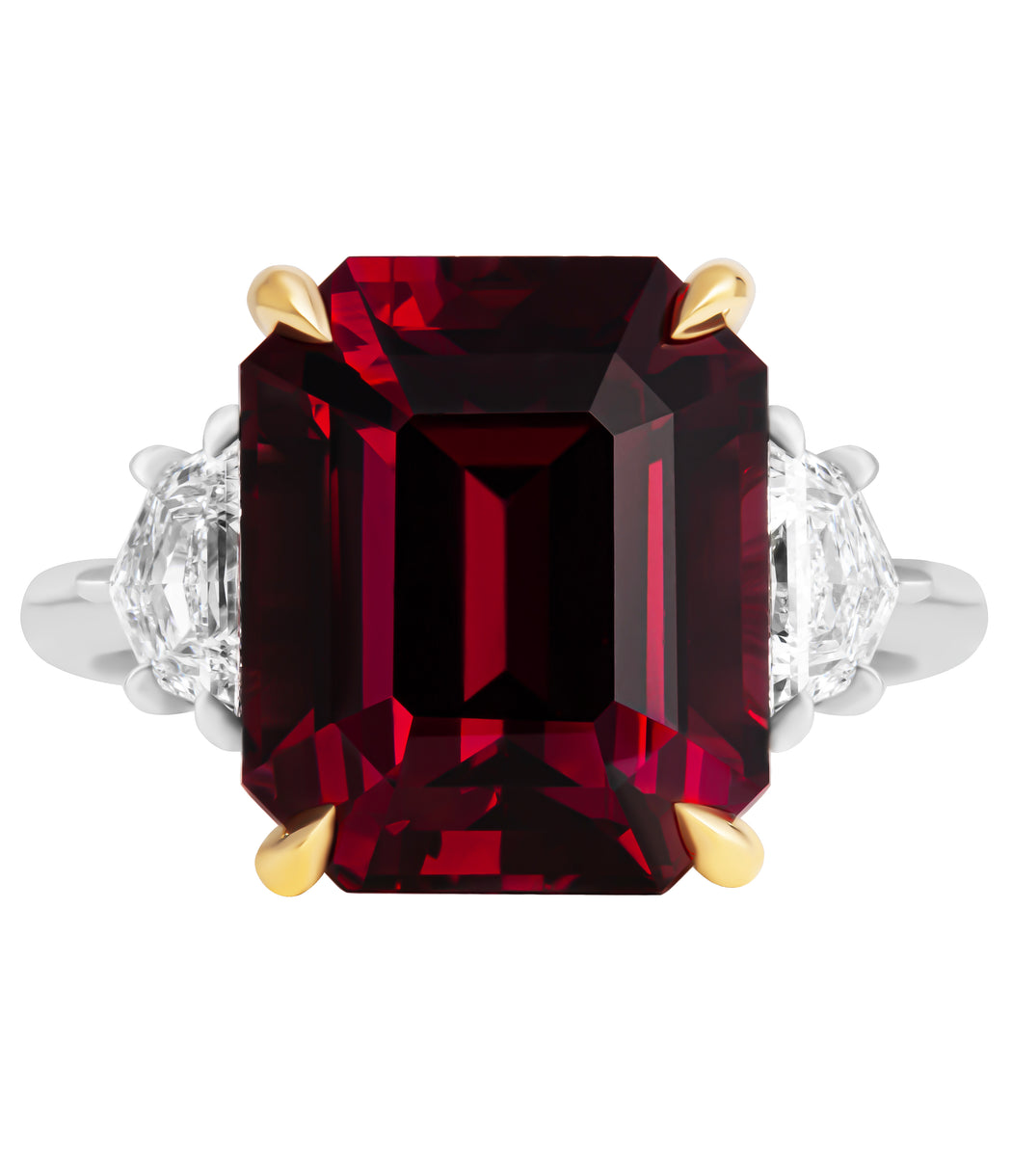 Three-stone ring with garnet center stone and diamond side stones in 18K yellow gold and platinum
