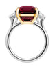 Three-stone ring with garnet center stone and diamond side stones in 18K yellow gold and platinum