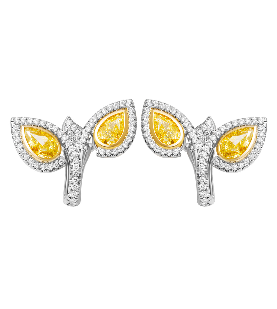 Bypass earrings in platinum and 18K yellow gold with fancy yellow pear-shaped diamonds and pavé diamond halo